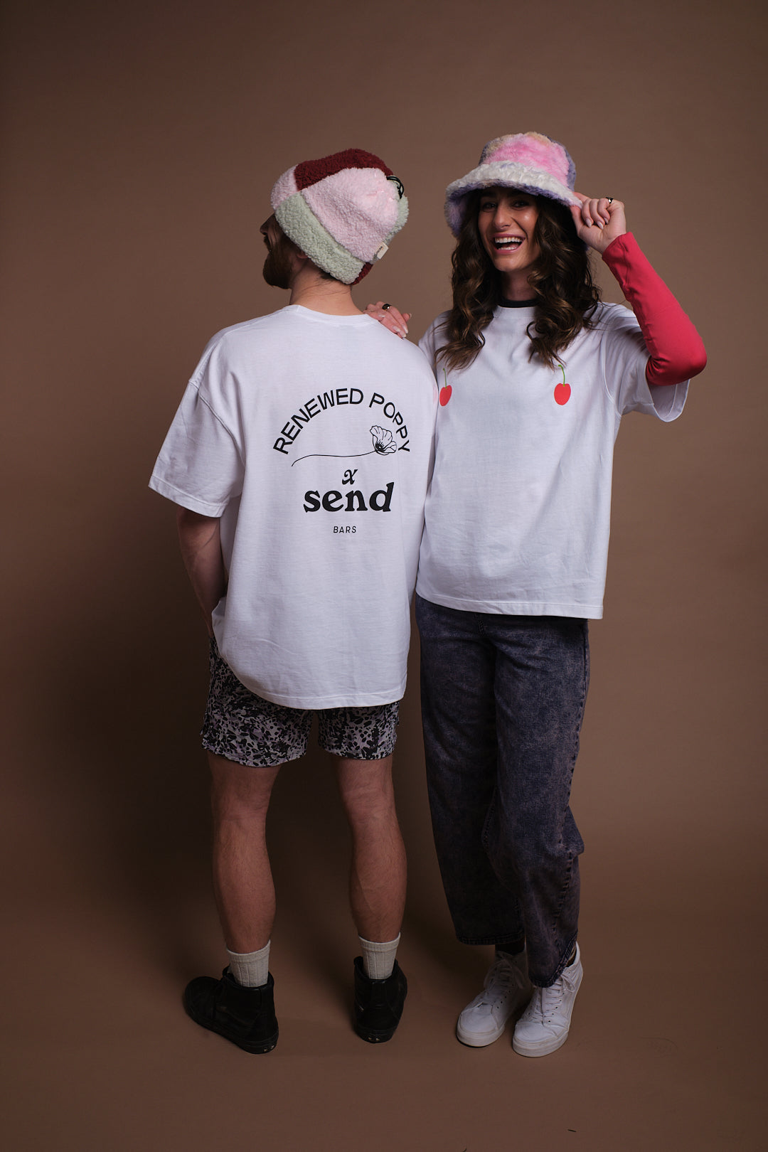 Two people wearing SEND and Renewed Poppy's limited edition t-shirt with SEND's cherry design. 